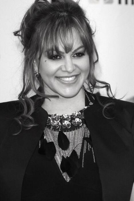 Jenni Rivera posing in a red carpet, black and white portrait