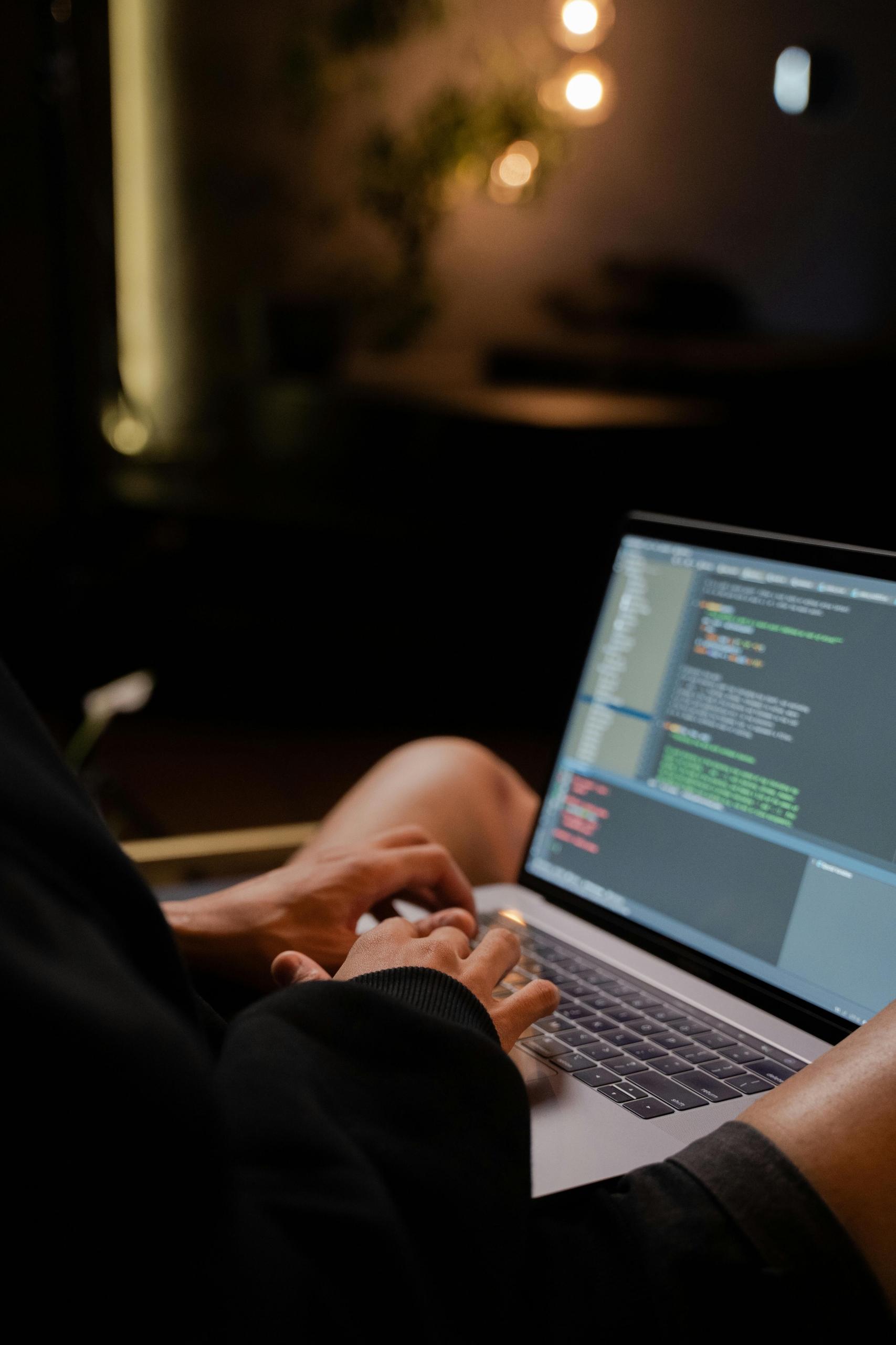 A person typing code on a laptop