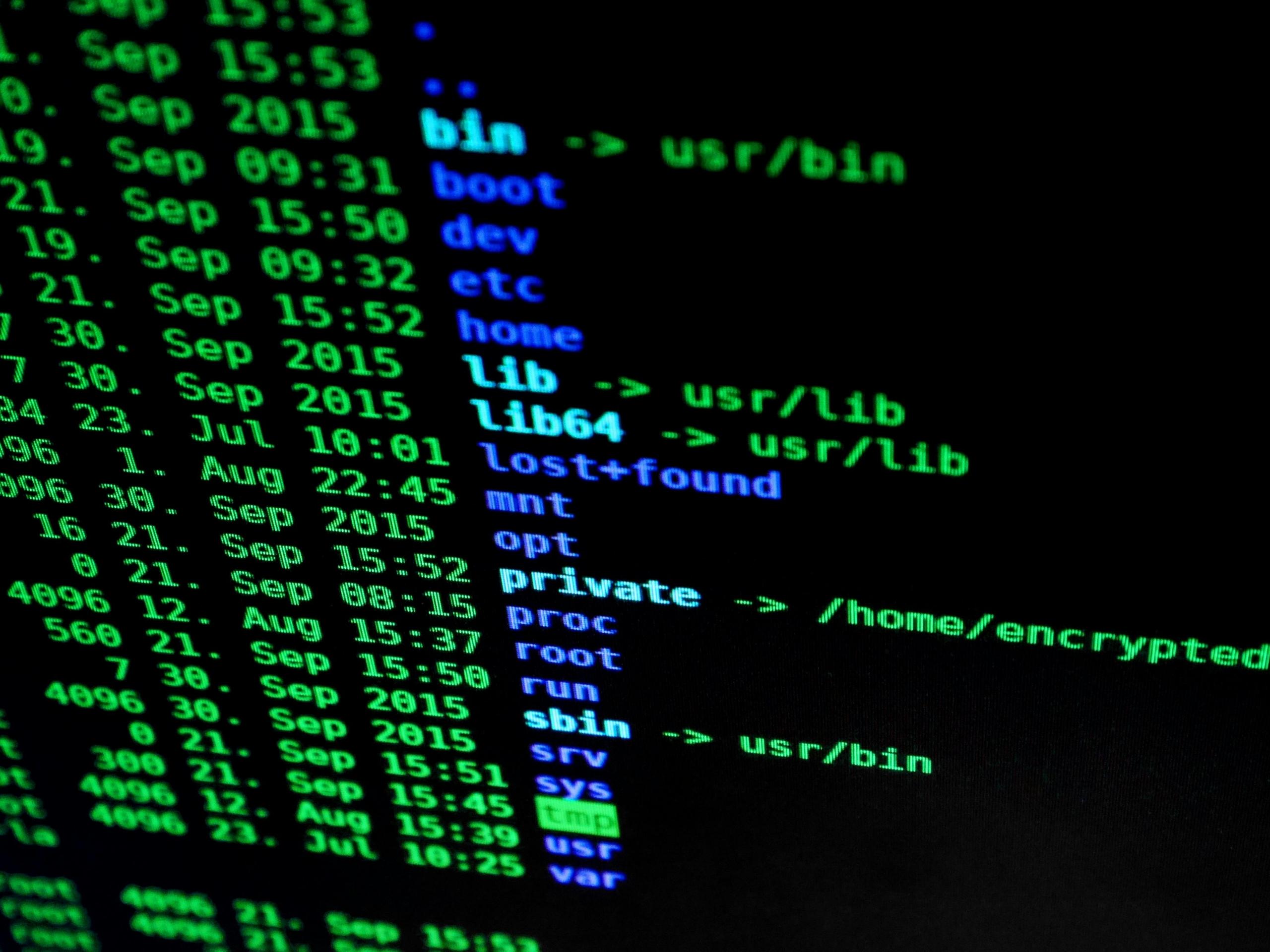 a laptop filled with multicolored code