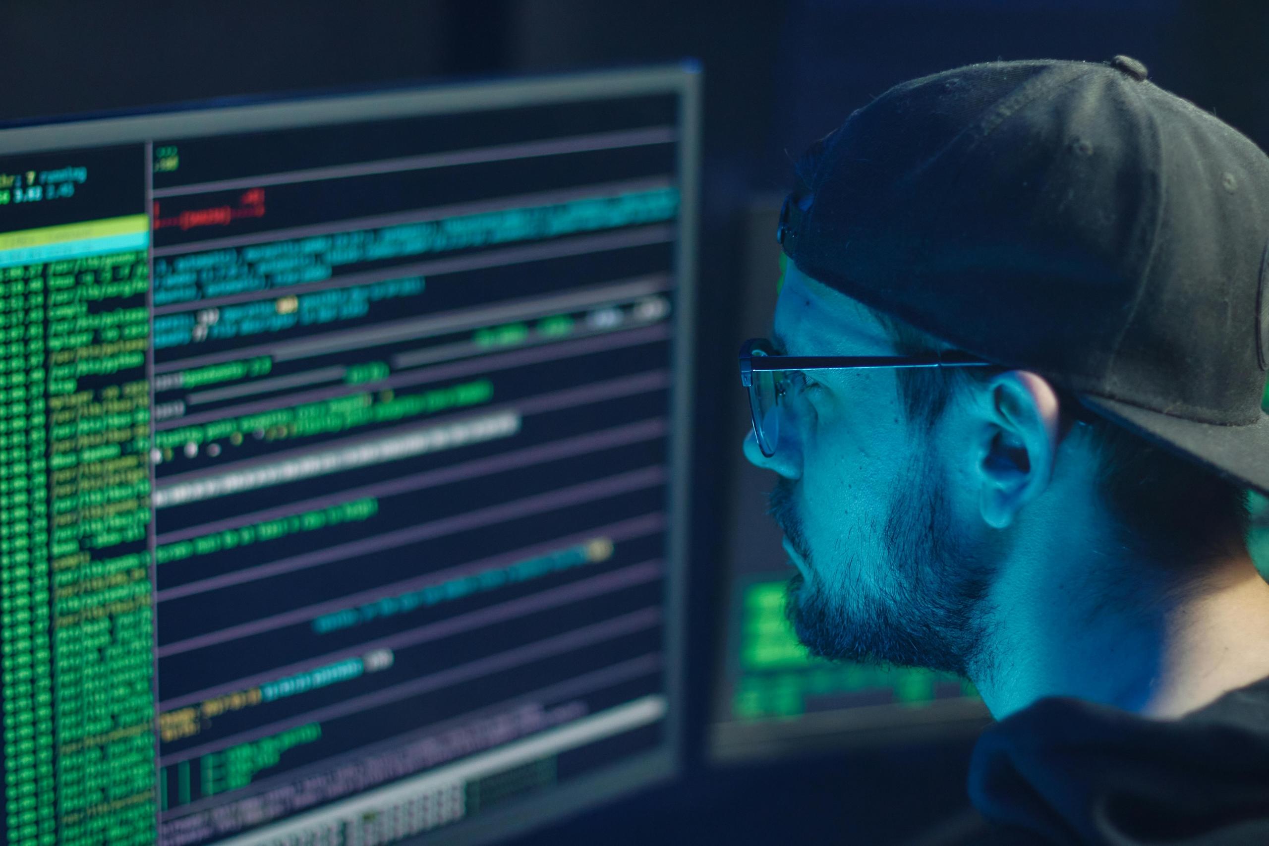 Man focused on computer coding