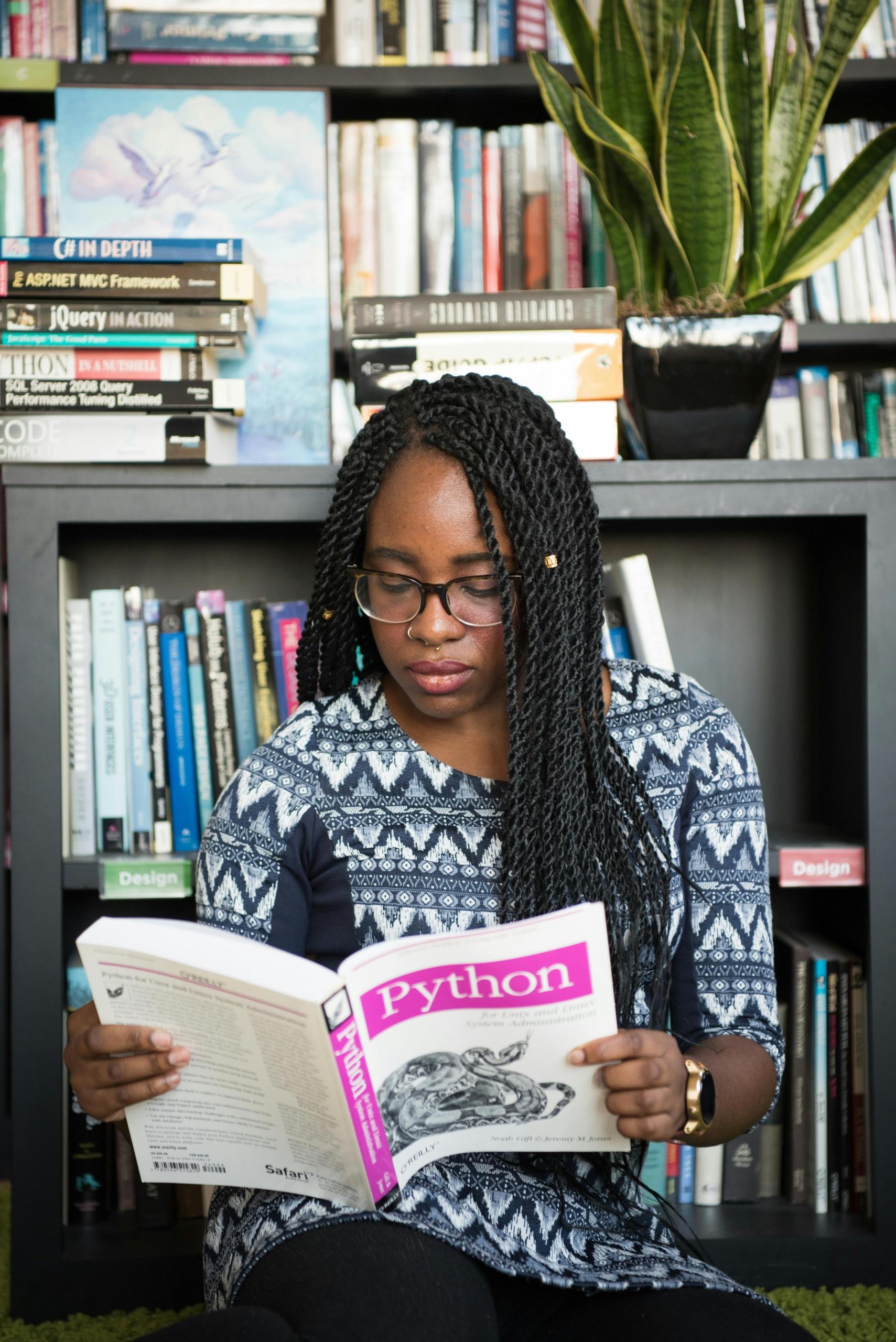Woman reading a book on Python