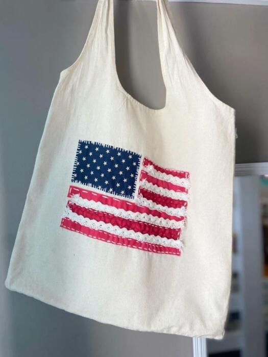 beige tote bag with embroidered American flag