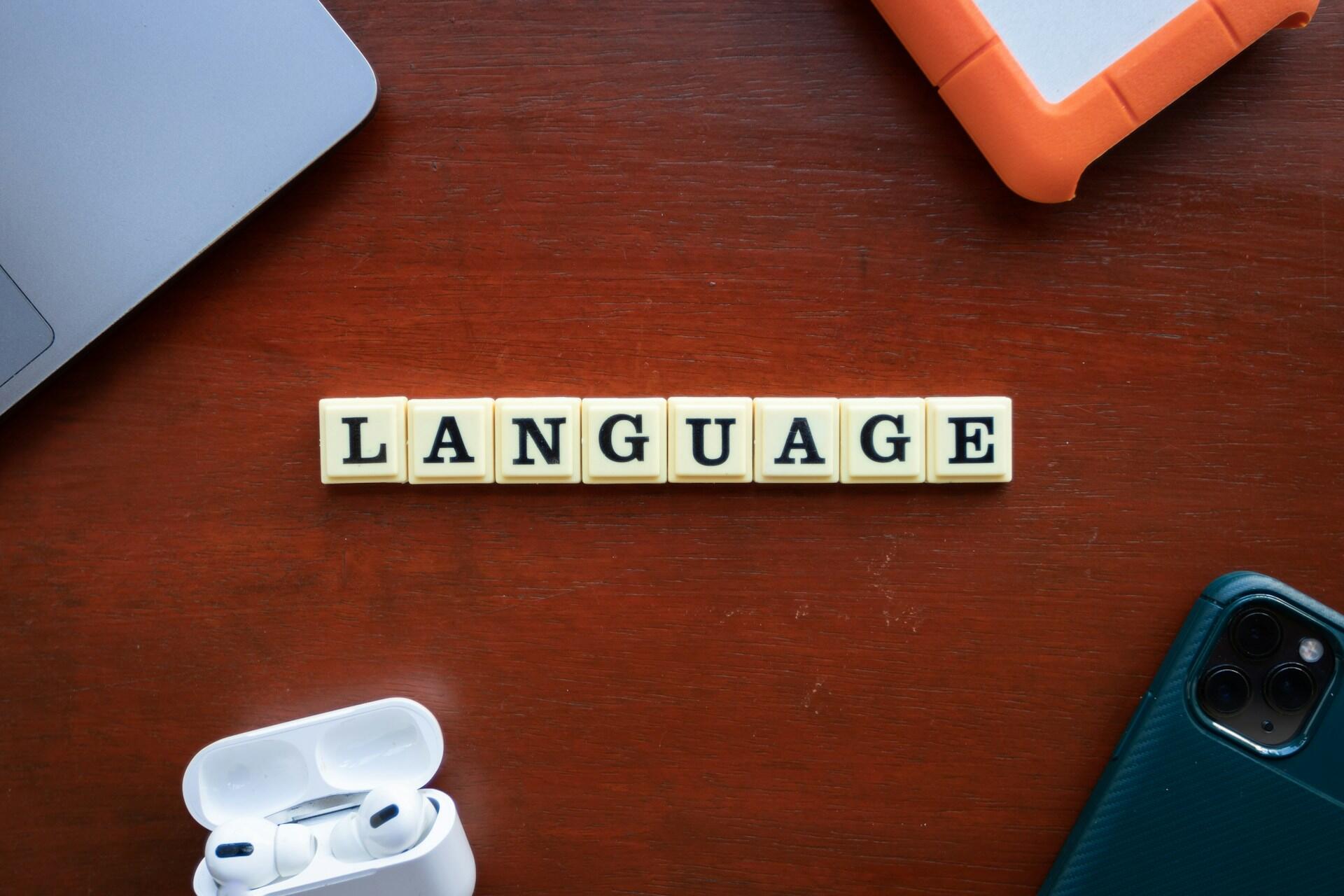 The word "language" written in Scrabble pieces.